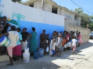 Haitian People in line for water after the water station opened in their community