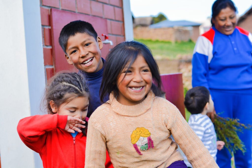 Mexican children playing near the water spout
